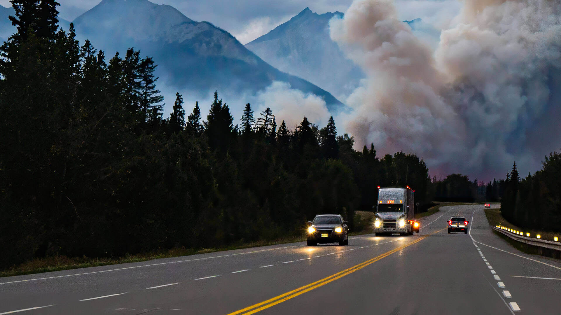 Driving on the highway into a huge wildfire